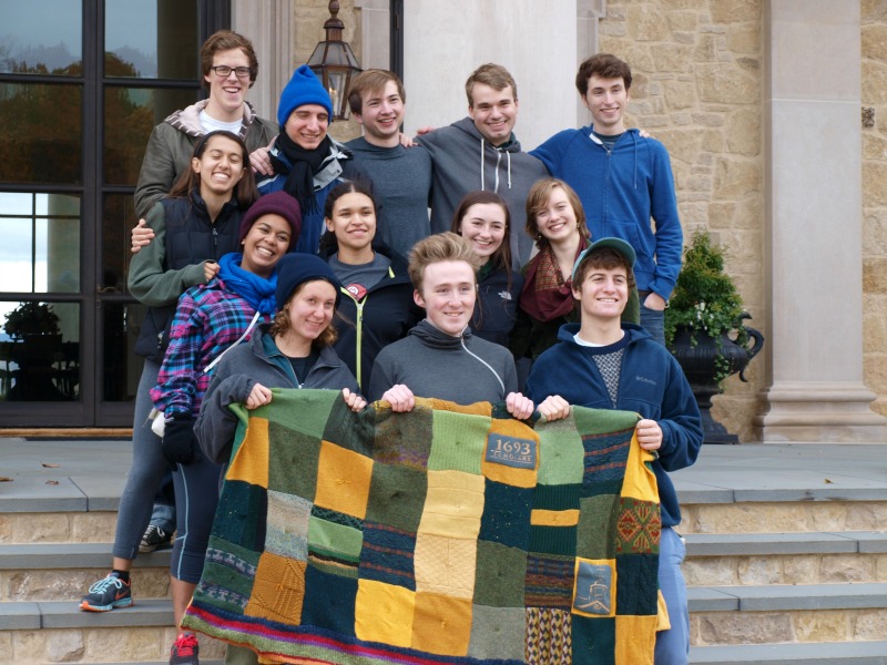 The students present a quilt to the Murrays